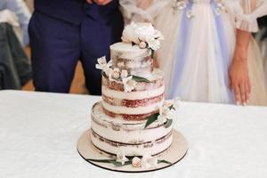 un' bellissimo nozze torta sta su il tavolo Il prossimo per il sposa e sposo foto