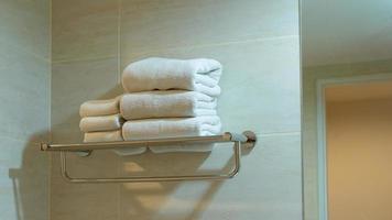 asciugamano su il inossidabile mensola nel bagno.concetto pulito piegato tessile per terme e igiene moderno interno Hotel camera foto