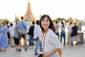 ritratto giovane bellissimo asiatico donna sorridente mentre viaggio a wat arun tramonto Visualizza punto, bangkok, Tailandia. foto