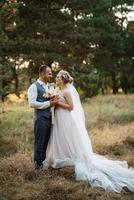 il sposo e il sposa siamo a piedi nel il foresta foto