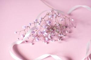 rosa tavoletta per testo con un' sfondo di bianca fiori e nastro foto