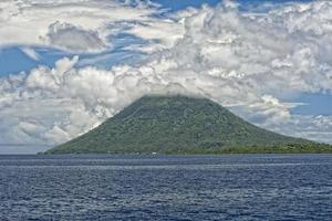 vulcano dietro a indonesiano pescatori villaggio tropicale Paradiso foto