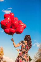 giovane donna con rosso cuore palloncini foto