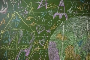 disegni di bambini con gesso su un' scuola verde tavola. foto