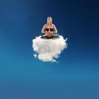 incinta donna fare yoga su un' nube foto