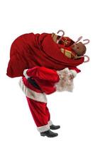 Santa Claus trasportare un' grande sacco pieno o Natale i regali foto