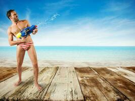 ragazzo giocare con acqua pistola foto