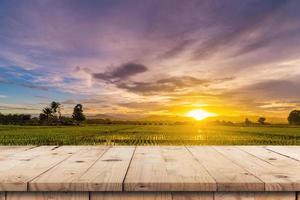 riso campo tramonto e vuoto legna tavolo per Prodotto Schermo e montaggio. foto