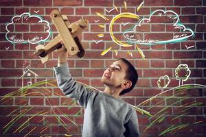 ragazzo giochi con un' di legno giocattolo aereo foto