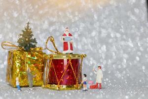 famiglia felice in miniatura che celebra il concetto di natale, natale e felice anno nuovo foto