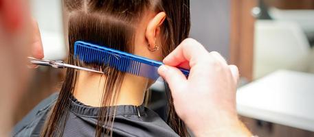 parrucchiere tagli via lungo capelli di donna foto