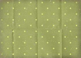 Vintage ▾ verde spiegazzato carta con bianca polka punti. vecchio logoro carta sfondo con crepe. foto