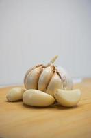 aglio e aglio Chiodi di garofano su un' di legno chopping tavola. aglio Prodotto foto nel foto studio. ritratti.