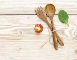 pomodoro e basilico con utensili in legno foto