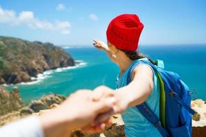 Seguire me - contento giovane donna nel un' rosso cappello e con un' zaino B foto