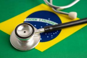 stetoscopio nero su sfondo bandiera brasile, concetto di affari e finanza. foto