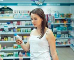 giovane donna shopping nel il memorizzare domestico sostanze chimiche e cosmetici foto