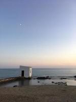 capanna del pescatore al tramonto in spiaggia foto