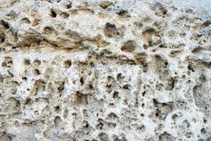 parete di roccia porosa per sfondo o texture foto