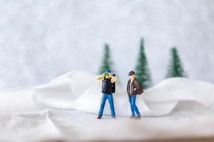 miniatura persone zaino in spalla viaggio nel inverno tempo foto