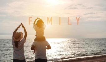 contento asiatico famiglia godere il mare spiaggia a consistente padre, madre e figlia avendo divertimento giocando spiaggia nel estate vacanza su il oceano spiaggia. contento famiglia con vacanze tempo stile di vita concetto. foto