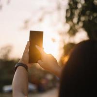 vicino su donna mano hold utilizzando inteligente Telefono su all'aperto parco strada sfondo. copia spazio di tecnologia attività commerciale e viaggio vacanza concetto. Vintage ▾ tono filtro effetto colore stile. foto