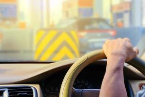 mano di uomo guida auto viaggio su strada traffico marmellata e luce del sole foto