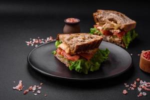 delizioso Sandwich con croccante pane abbrustolito, pollo, pomodori e lattuga foto