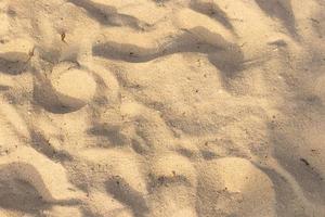 sabbia sulla trama spiaggia per sfondo estivo foto