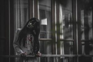 ritratto di donna asiatica make up fantasma, scena horror spaventosa per lo sfondo, concetto di festival di halloween, poster di film di fantasmi, spirito arrabbiato nell'appartamento foto
