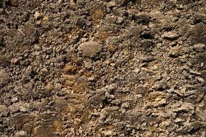 trama di sfondo dalla superficie sciolta del suolo di sabbia e terra foto
