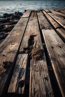 vecchio di legno molo su il spiaggia a tramonto. selettivo messa a fuoco foto