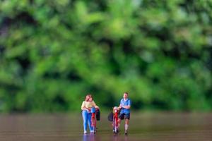 miniatura persone in piedi con bicicletta, mondo bicicletta giorno concetto foto