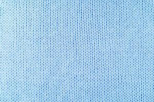 luminosa blu maglieria lana tessuto struttura sfondo. astratto tessile fondale foto