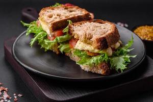 delizioso caprese Sandwich con grigliato pane abbrustolito, Mozzarella, lattuga e pomodori foto