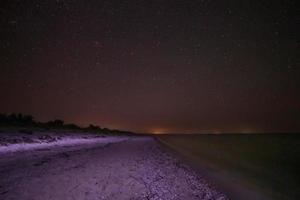 vista di sabbioso spiaggia a notte foto