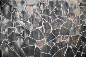ardesia pietra struttura, naturale pietra di fango parete di irregolare poligoni nel grigio Marrone colore foto