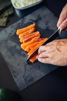 tagliare il salmone per il sushi foto