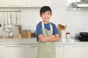 ritratto di inteligente ragazzo sorridente nel cucina a casa foto