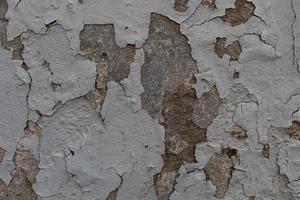 sfondo di vecchio colorato parete con Cracked gesso nel avvicinamento foto
