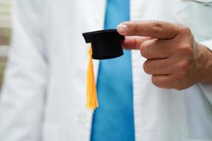 donna asiatica medico che tiene il cappello di laurea in ospedale, concetto di educazione medica. foto