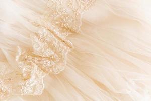 elegante beige tulle con floreale pizzo Cucitura. morbido tulle pieghe. Perfetto nozze sfondo per design. foto