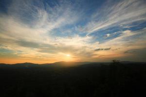 bellissimo paesaggio strati di montagna e nebbioso su collina valle nel d'oro crepuscolo di tramonto a Tailandia foto