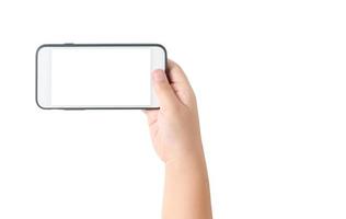 bambino mano hold mobile Telefono con vuoto bianca schermo foto