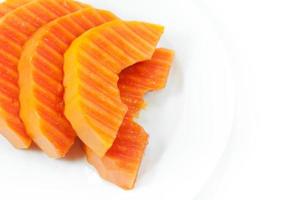 maturo papaia frutta affettato su un' bianca piatto su bianca sfondo foto