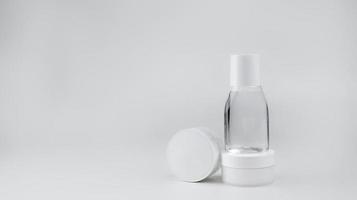 bianca contenitori con cosmetici viso crema, mano crema, miscellaneo acqua su un' bianca sfondo, disposte verticalmente foto