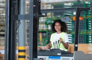 lavoratore nel auto parti magazzino uso un' carrello elevatore a forca per opera per portare il scatola di auto parti in il Conservazione mensola di il magazzino in attesa per consegna per il auto montaggio linea foto