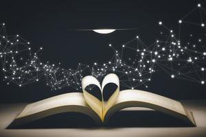 a forma di cuore pieghevole libro nel il d'oro bokeh sfondo, concetto idee per lettura e amore, focalizzazione morbida bokeh sfondo, concetto il idea di lettura libri, conoscenza, e ricerca per nuovo idee. foto