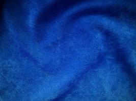 struttura del tessuto di velluto blu utilizzata come sfondo. sfondo di tessuto blu vuoto di materiale tessile morbido e liscio. c'è spazio per il testo. foto