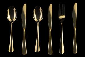 oro coltello e cucchiaio e forchetta su un' nero sfondo. posate. foto